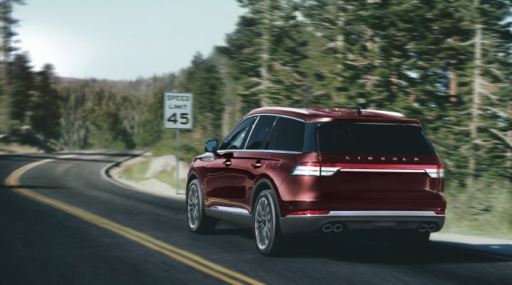 A 2024 Lincoln Aviator® SUV is being driven on a winding mountain road | Sheehy Lincoln of Gaithersburg in Gaithersburg MD