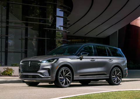 A gray 2025 Lincoln Aviator® SUV is parked outside a modern building showcasing the driver’s side of the vehicle. | Sheehy Lincoln of Gaithersburg in Gaithersburg MD