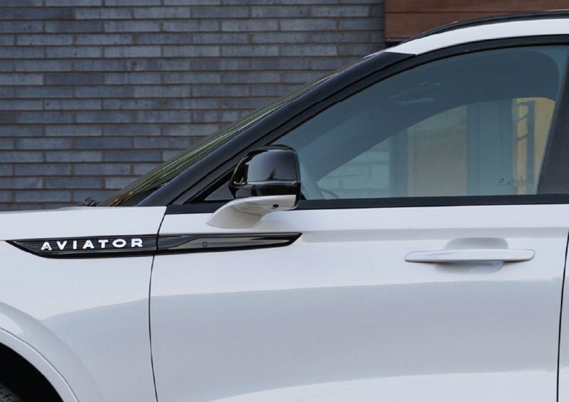 The driver’s side door and fender badging of a white 2026 Lincoln Aviator® SUV are showcased. | Sheehy Lincoln of Gaithersburg in Gaithersburg MD