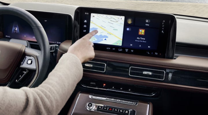 A person is tapping the center display touchscreen of a 2026 Lincoln Aviator® SUV. | Sheehy Lincoln of Gaithersburg in Gaithersburg MD