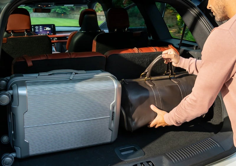 A man loads luggage into the rear of a 2026 Lincoln Aviator® SUV through the opened rear liftgate. | Sheehy Lincoln of Gaithersburg in Gaithersburg MD