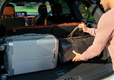 A man loads luggage into the rear of a 2026 Lincoln Aviator® SUV through the opened rear liftgate. | Sheehy Lincoln of Gaithersburg in Gaithersburg MD