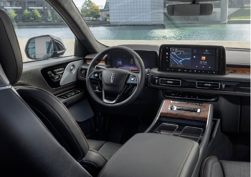 The interior of the 2026 Lincoln Aviator® SUV is shown parked with a view of a harbor through the windshield. | Sheehy Lincoln of Gaithersburg in Gaithersburg MD