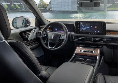 The interior of the 2026 Lincoln Aviator® SUV is shown parked with a view of a harbor through the windshield. | Sheehy Lincoln of Gaithersburg in Gaithersburg MD