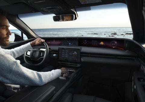 A driver of a parked 2026 Lincoln Nautilus® SUV takes a relaxing moment at a seaside overlook while inside his Nautilus. | Sheehy Lincoln of Gaithersburg in Gaithersburg MD