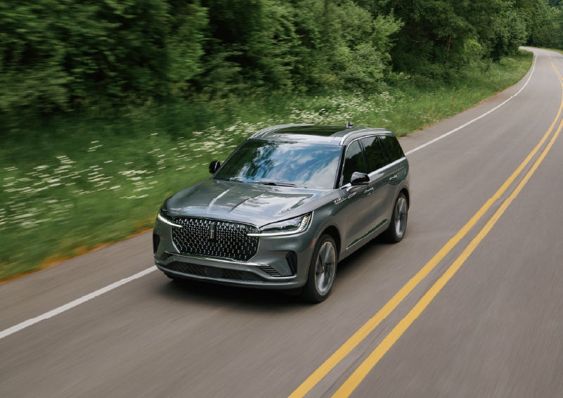 A 2027 Lincoln Aviator® SUV is being driven down a road. | Sheehy Lincoln of Gaithersburg in Gaithersburg MD