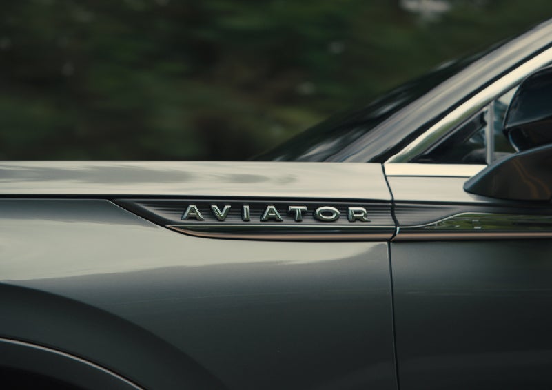 The driver’s side door and fender badging of a gray 2027 Lincoln Aviator® SUV are showcased. | Sheehy Lincoln of Gaithersburg in Gaithersburg MD