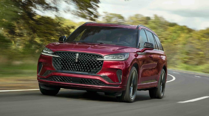 A 2027 Lincoln Aviator® SUV is being driven on a country road | Sheehy Lincoln of Gaithersburg in Gaithersburg MD