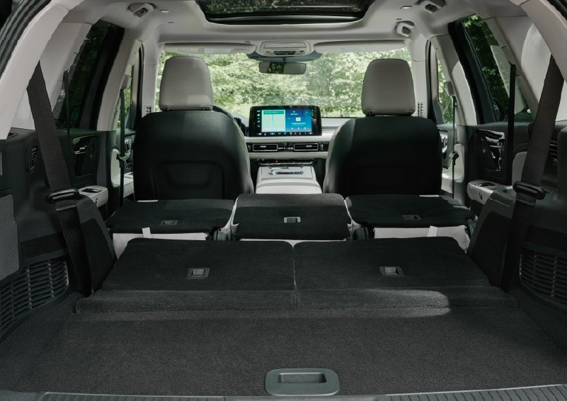 A rear to front view of the interior of a 2027 Lincoln Aviator® Black Label™ SUV shows the third and second rows folded flat | Sheehy Lincoln of Gaithersburg in Gaithersburg MD
