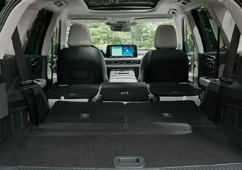 A rear to front view of the interior of a 2027 Lincoln Aviator® Black Label™ SUV shows the third and second rows folded flat | Sheehy Lincoln of Gaithersburg in Gaithersburg MD