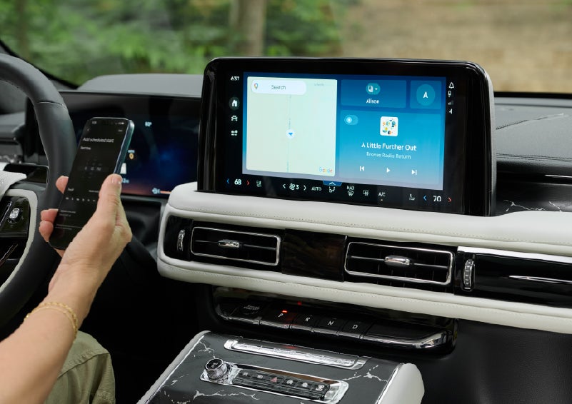 A person pairs thier phone with the center touchscreen of a 2027 Lincoln Aviator® Black Label™ SUV | Sheehy Lincoln of Gaithersburg in Gaithersburg MD